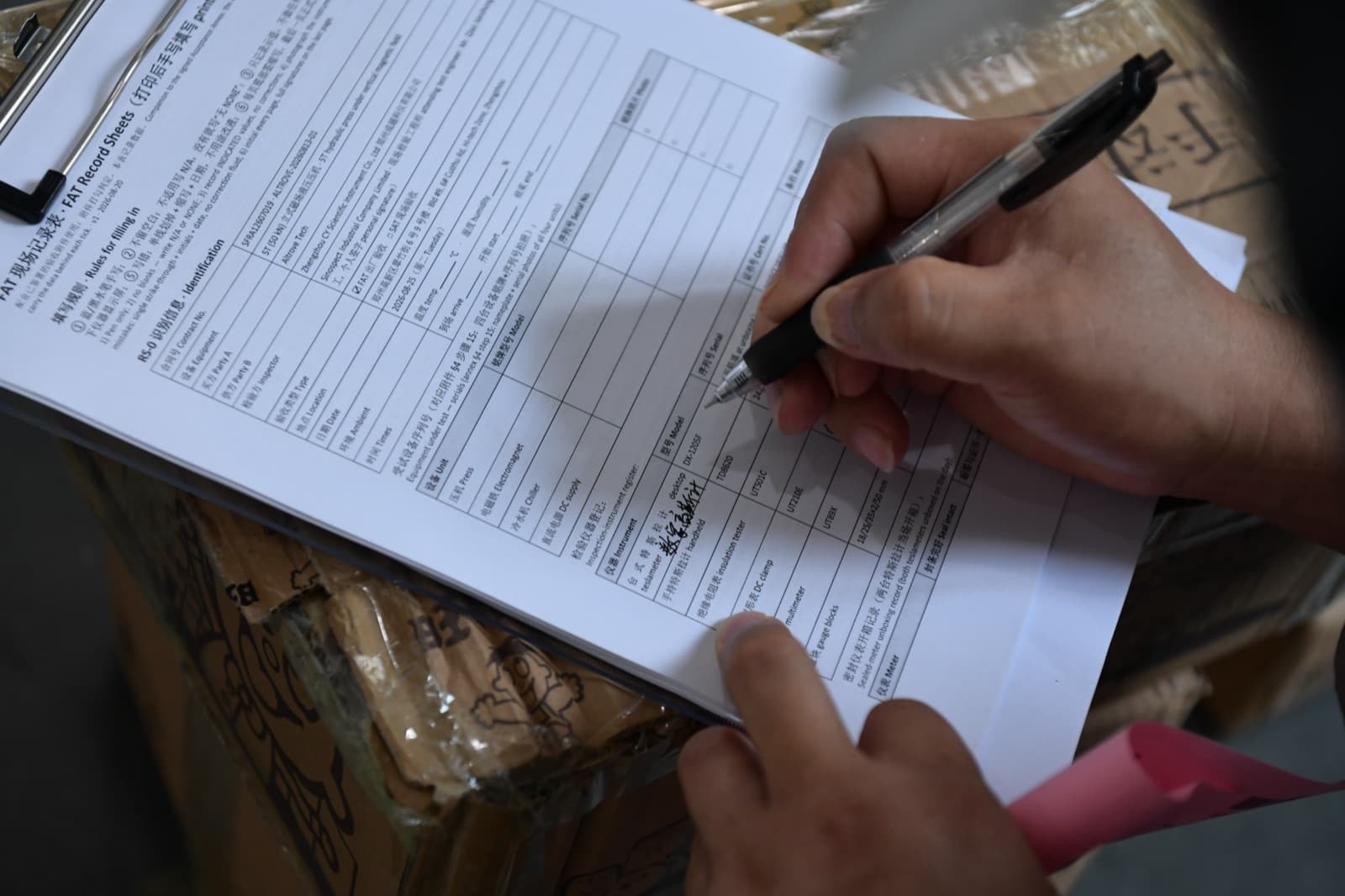 Factory acceptance record sheet being completed by hand during a witnessed test at a supplier works