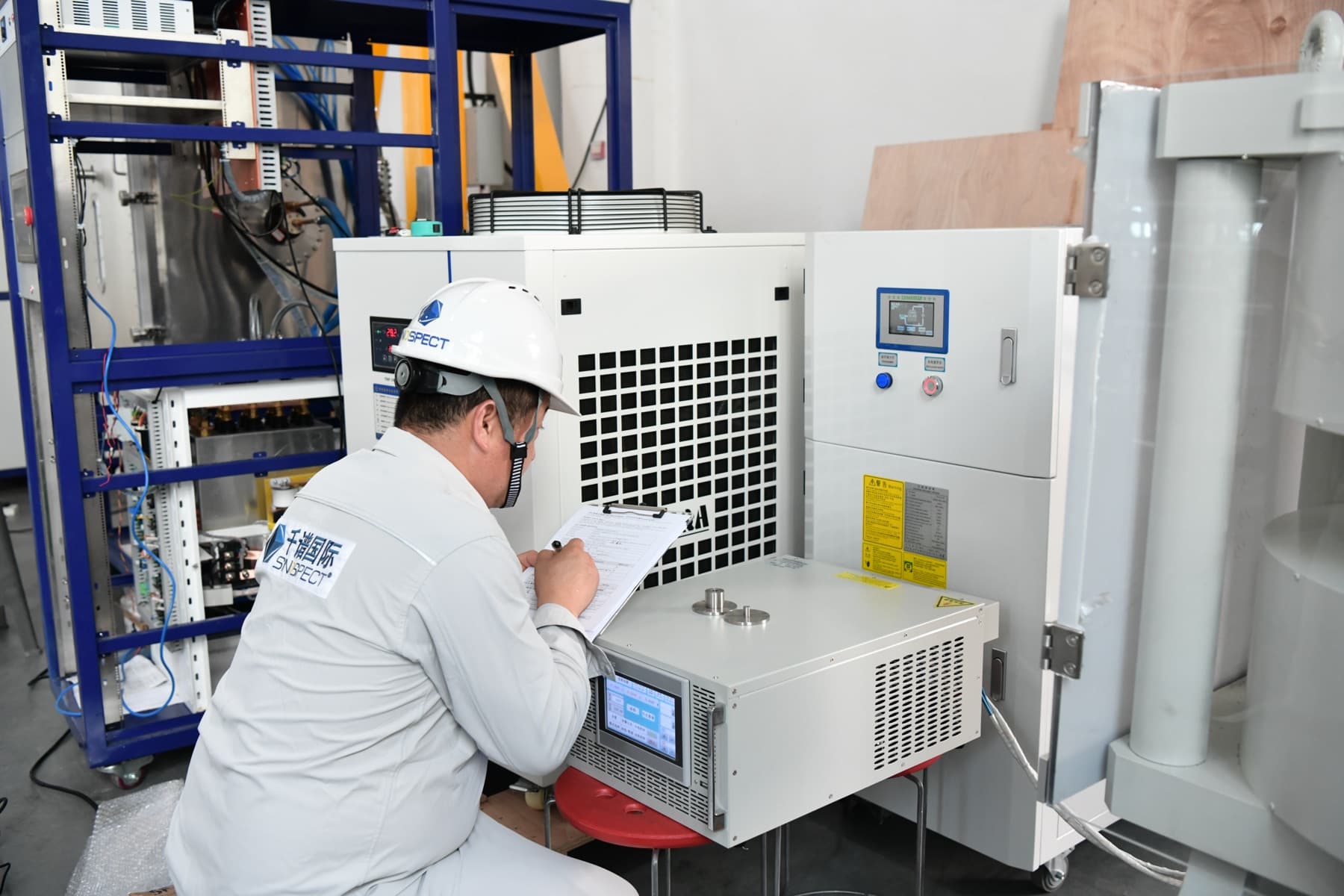 Sinospect engineer recording instrument readings during a witnessed factory acceptance test