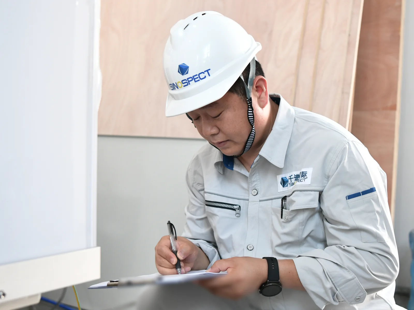 Sinospect QA/QC Engineer Qiao recording observations during a formal factory acceptance test in China