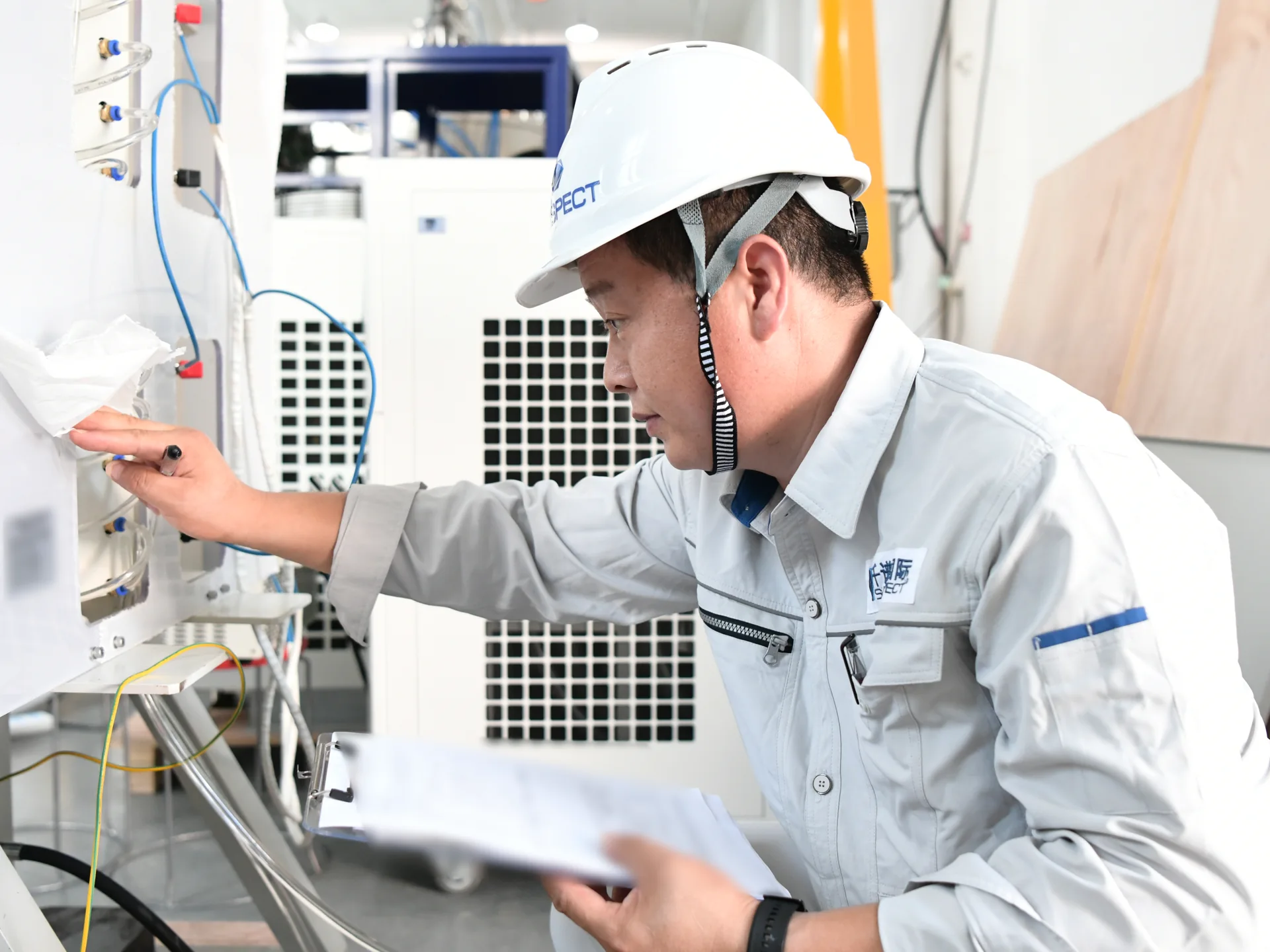 Sinospect QA/QC Engineer Qiao checking test equipment against the FAT record at a supplier facility in China