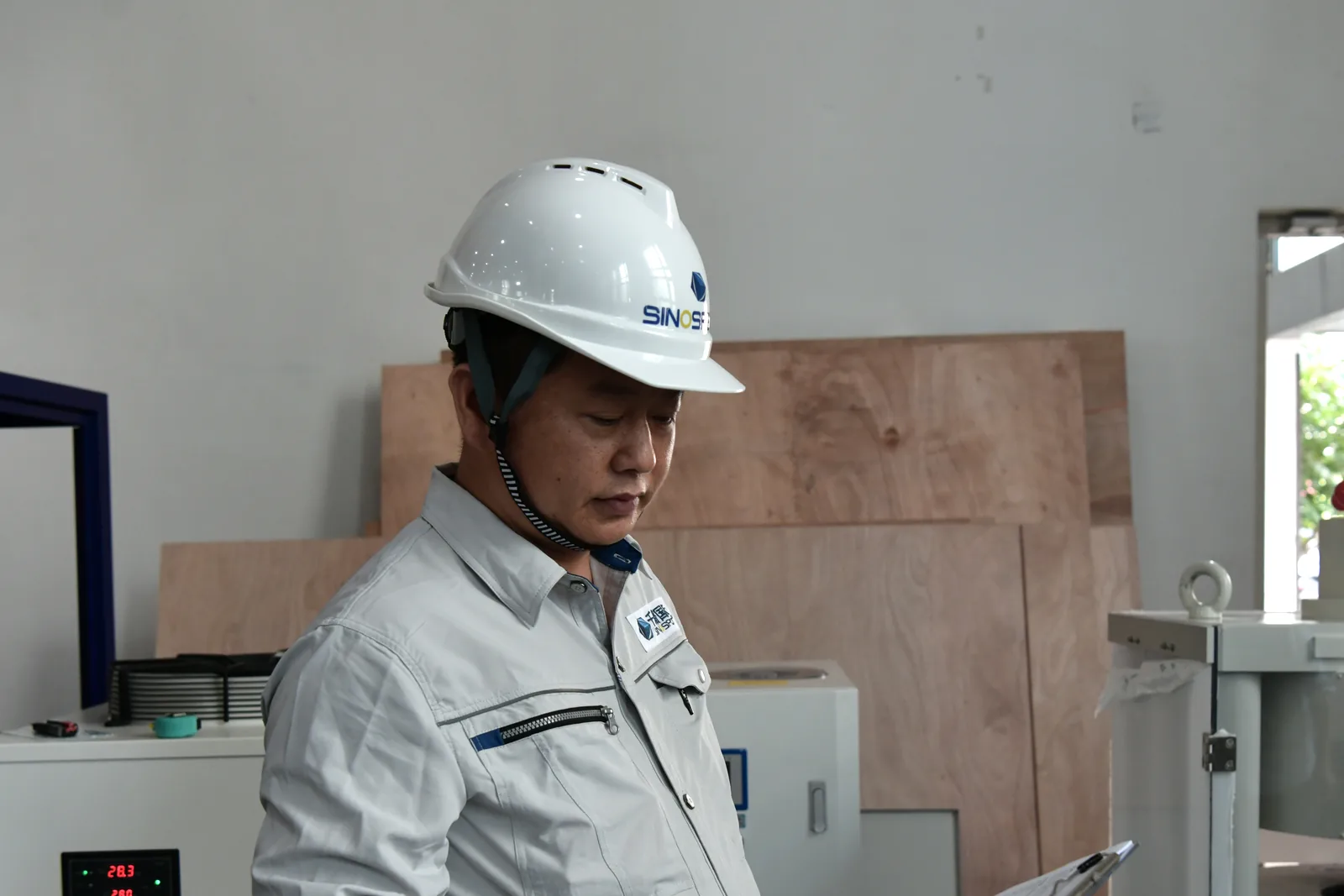Sinospect QA/QC Engineer Qiao checking equipment against the inspection record at a supplier facility in China