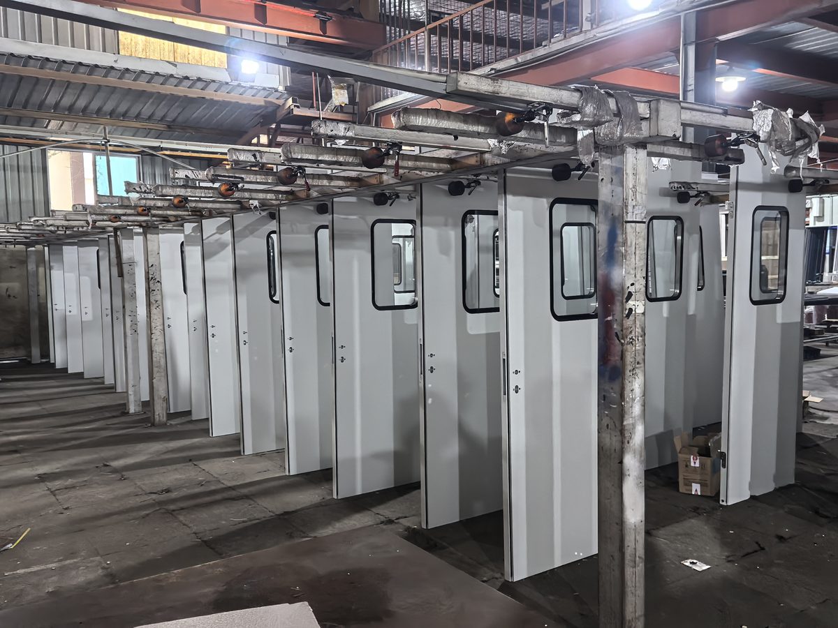 Factory production line inspection — industrial doors manufactured for export