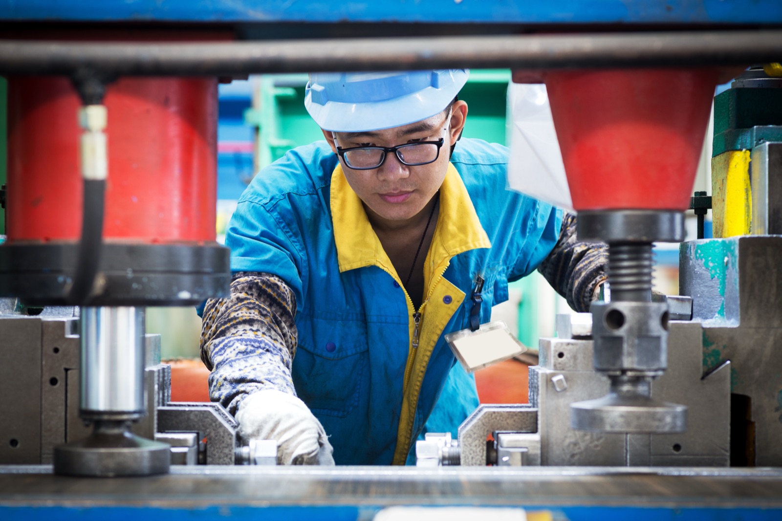 Machinist setting up press tooling on a production line in a Chinese factory.